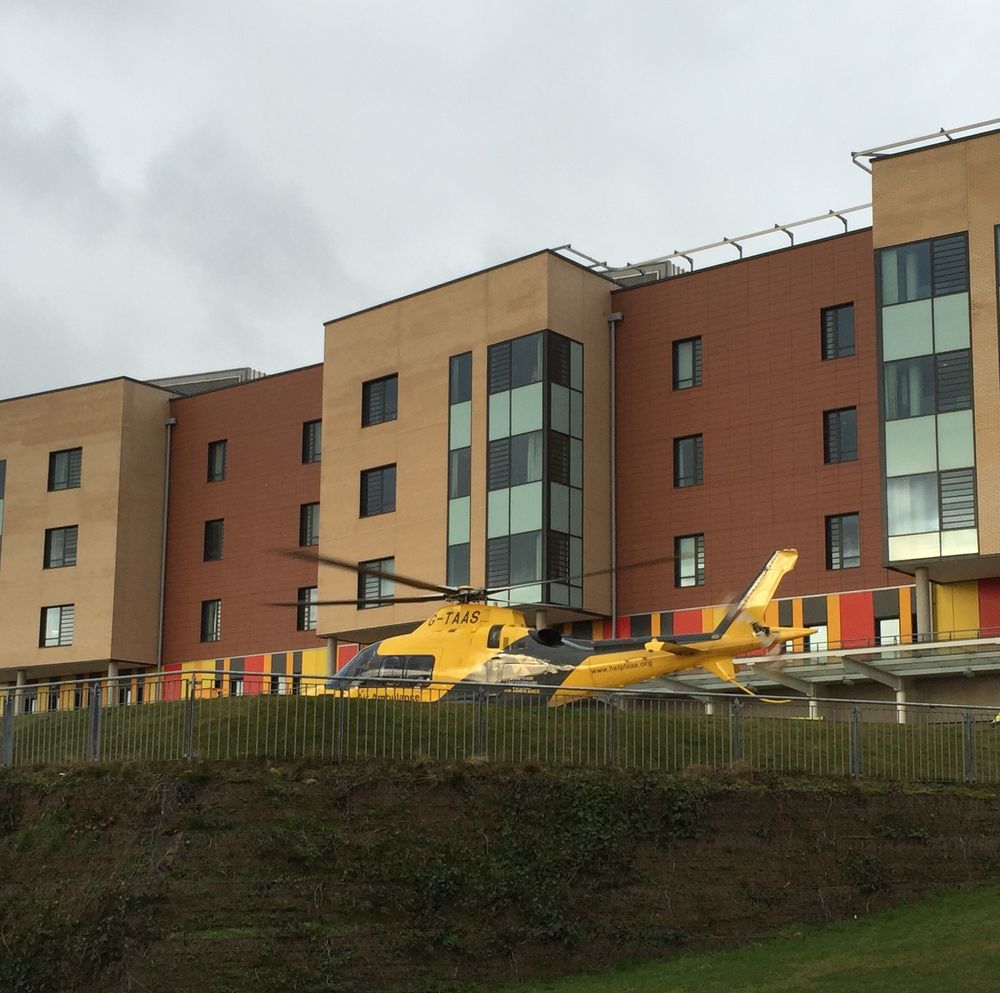 An air ambulance helicopter on the helipad of a hospital.